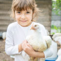 young girl holding chicken